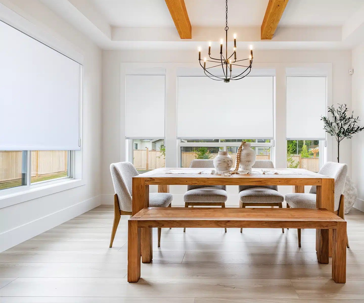 AutoWand™ motorization Roller shades in dining area